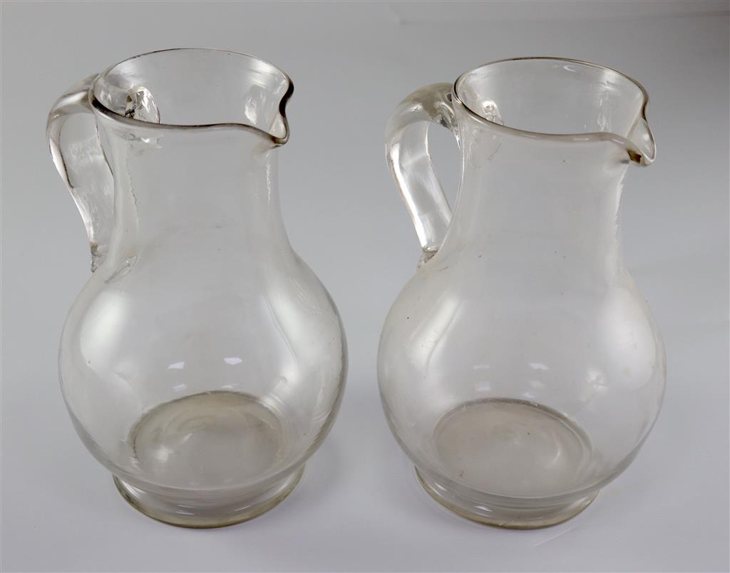 A pair of Georgian glass plain baluster jugs, first half 18th century,